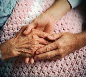 Picture of an elderly hand in two other hands
